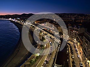 Aerial view of popular Promenade des Anglais with beach Plage des Ponchettes in the center of Nice, France in the evening.