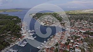 Aerial view of port in Milna, Croatia, drone view point, a full rainbow on the horizon, islands, is parked yachts