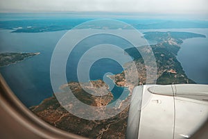 Aerial view through porthole of aircraft, flying over Thessaloniki,Croatia,Istria