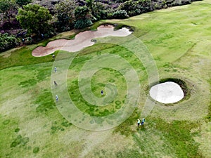 Aerial view of pound on golf course with player.