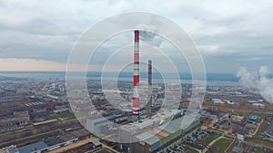 Aerial view of power plants, thermal power station. Smoking pipe at industrial area.