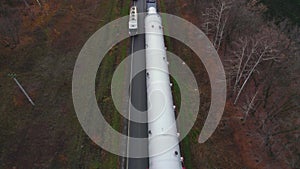 Aerial view. A powerful tractor pulls oversized cargo. A huge metal column for the chemical industry.