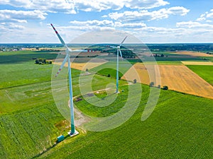 Aerial view of powerful Wind turbine farm for energy production on beautiful cloudy sky at highland. Wind power turbines