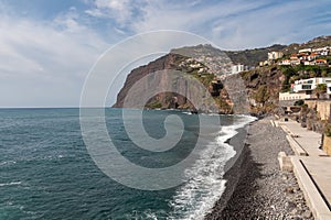 Aerial view of Praia de Vigario in Camara de Lobos on Madeira island, Portugal, Europe. Black stone beach in Atlantic Ocean