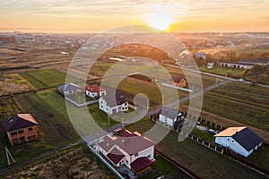 Aerial view of private homes in rural suburban area at sunset