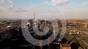 Aerial view of production plant, industrial area with tall chimneys billowing smoke. Factory landscape. Air Pollution