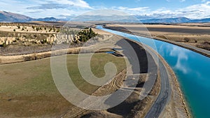 Aerial view of the Pukaki hydro power scheme canal in Twizel running in alongside the snow capped Ben Ohau mountain range