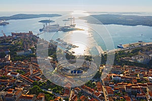 Aerial view of Pula in Croatia with Roman Amphitheatre, marina and port at sunset. Istria, Europe