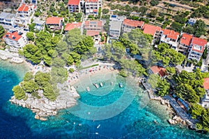 Aerial view of Punta Rata beach with boats and azure sea in Brela, Croatia, Dalmatia, Croatian azure coast