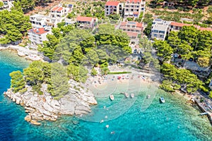 Aerial view of Punta Rata beach with boats and azure sea in Brela, Croatia, Dalmatia, Croatian azure coast