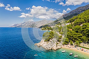 Aerial view of Punta Rata beach with boats and azure sea in Brela, Croatia, Dalmatia, Croatian azure coast