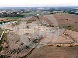 Aerial view of a quarry with conveyor belt and wheel loader - stones and sands for construction - top view , open pit mine, extrac