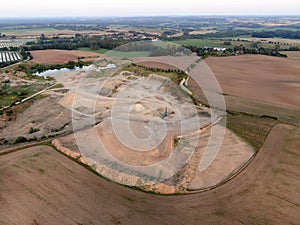 Aerial view of a quarry with conveyor belt and wheel loader - stones and sands for construction - top view , open pit mine, extrac