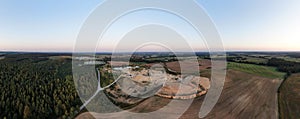 Aerial view of a quarry with conveyor belt and wheel loader - stones and sands for construction - top view , open pit mine, extrac