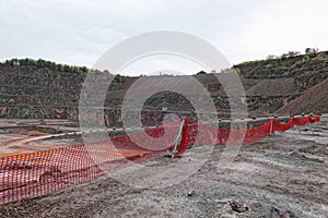 Aerial view into a quarry mine of porphyry rocks.