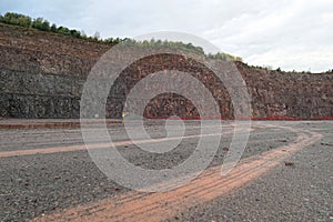 Aerial view into a quarry mine of porphyry rocks.