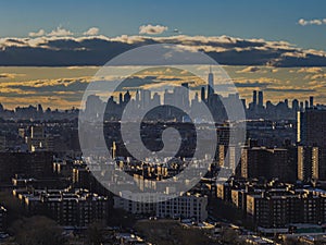 Aerial view of Queens, New York before a sunset with buildings in the foreground