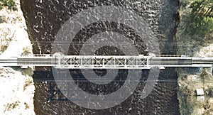 Aerial view on the rail bridge across the river in rural place in spring