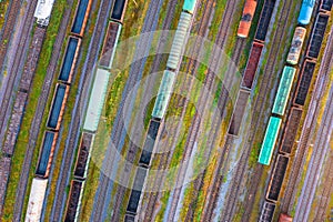 Aerial view of rail sorting freight station with railway cars, with many rail tracks railroad. Heavy industry landscape on evening