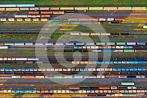 Aerial view of rail sorting freight station with railway cars, with many rail tracks railroad. Heavy industry landscape on evening