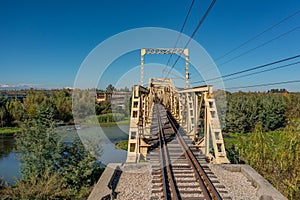 Aerial view of the railroad bridge above a river in Maule region, Chile. Top view of the railroad from drone