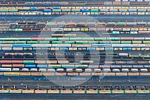 Aerial view of railroad tracks, cargo sorting station. Many different railway cars with cargo and raw materials