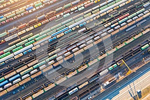 Aerial view of railroad tracks long trains, cargo sorting station. Many different railway cars with cargo and raw materials