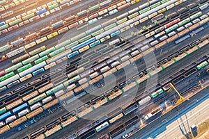 Aerial view of railroad tracks long trains, cargo sorting station. Many different railway cars with cargo and raw materials photo