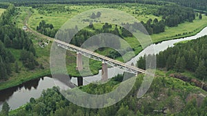 Aerial view of the railway bridge over the river in the forest