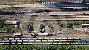 Aerial view of the railway with moving and standing in several rows of wagons.