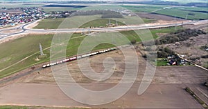 aerial view of railway with moving train with carriages