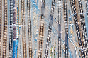 Aerial view of railway station with wagons and rail swicthes. Top down view. Reconstructed modern railway infrastructure