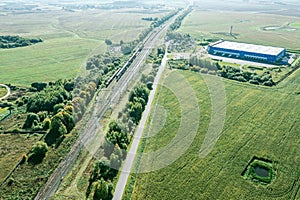 Aerial view of railway track and logistic center in rural area