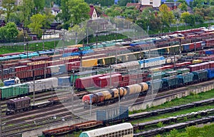 Aerial view of railway yard with freight rail wagons. Cargo trains with goods on railroad. Freight train with petroleum tank cars