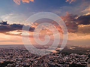 Aerial view on rain clouds at sunset over the city