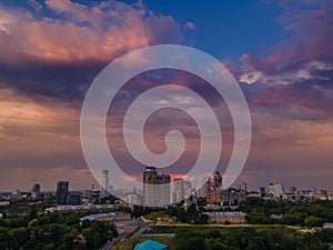 Aerial view on rain clouds at sunset over the city