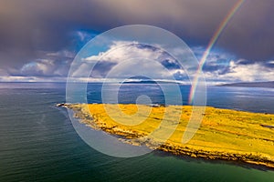 Aerial view of an rainbow above the Atlantic Ocean and Inishkeel by Portnoo in Donegal - Ireland