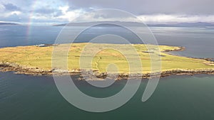 Aerial view of an rainbow above the Atlantic Ocean and Inishkeel by Portnoo in Donegal - Ireland