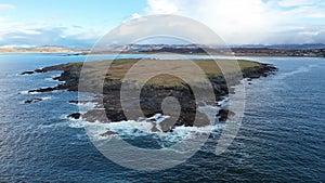 Aerial view of an rainbow above the Atlantic Ocean and Inishkeel by Portnoo in Donegal - Ireland