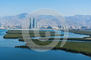 Aerial view of Ras al Khaimah, United Arab Emirates north of Dubai, looking at the city, Hajar mountains - Jebal Jais - and the photo