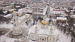 Aerial view of reconstructed five domed church and bell tower of Spassky Cathedral in Penza on background with cityscape