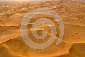 Aerial view of red Desert Safari with sand dune in Dubai City, United Arab Emirates or UAE. Natural landscape background at sunset