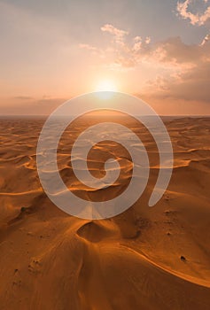 Aerial view of red Desert Safari with sand dune in Dubai City, United Arab Emirates or UAE. Natural landscape background at sunset