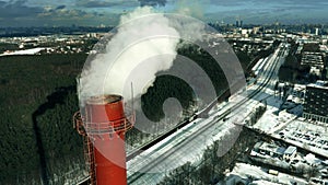 Aerial view of a red industrial smokestack in winter