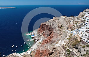 Aerial view on red rocks and small port under them at Santorini island, Greece