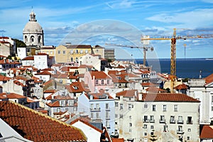 Aerial view of the red roofs of Alfama the historic area of Lisbon on the coast of the Atlantic Ocean.