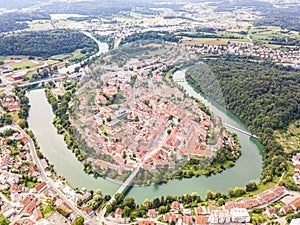 Aerial view of red roofs of Novo Mesto, Slovenia. Historic Kandija iron bridge Old Bridge, on the bend of the Krka River.