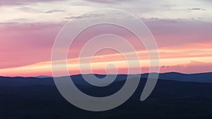 Aerial view of the red sunset over the forest