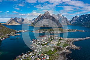 Aerial view of Reine, Lofoten islands, Norway. The fishing village of Reine. Spring time in Nordland. Blue sky. View from above