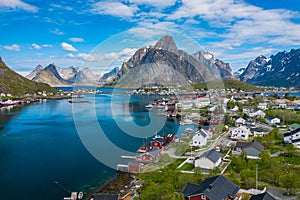 Aerial view of Reine, Lofoten islands, Norway. The fishing village of Reine. Spring time in Nordland. Blue sky. View from above